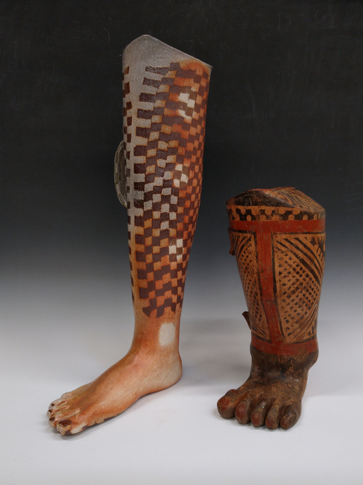 This piece by artist Isa Rodriguez shows a contemporary ceramic sculpture of the artists leg shown side-by-side with a pre-columbian leg-shaped ceramic effigy vessel.
